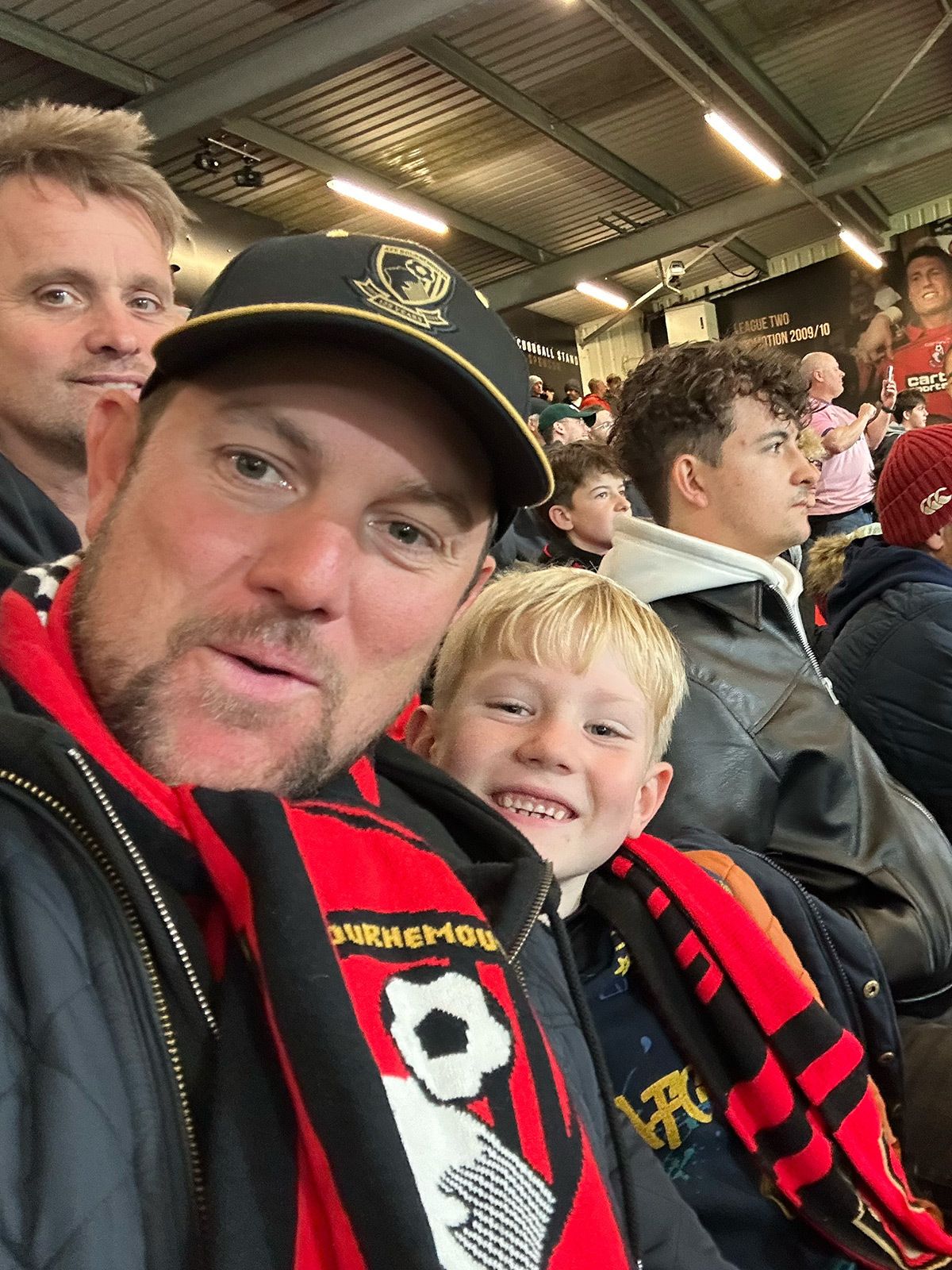 Carl and his son at a football match.